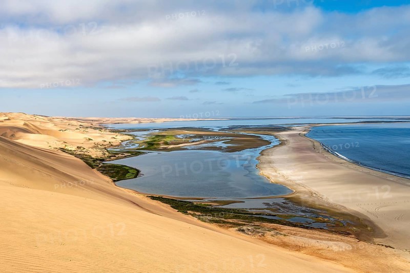 Sand dunes and sea, Sandwich Harbour Atlantic coast and lagoon, Namib Naukluft Park, Namib Desert, Namibia