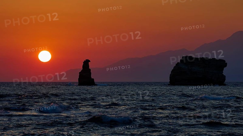 Atmospheric sunset over the sea with rocks and gentle waves, sunset, south of the Amari Basin, Central Crete, Triopetra, rocks in the sea, Crete, Greek Islands, Greece
