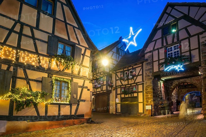 Colour-illuminated and Christmassy decorated half-timbered houses, blue hour, Christmas market, Riquewihr, Grand Est, Haut-Rhin, Alsace, France