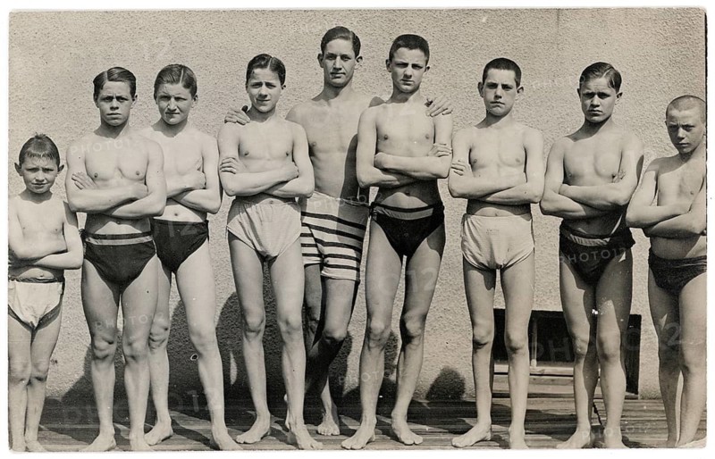 Bathing, swimwear, leisure, summer, boys and young people standing with folded arms in front of a stone wall, around 1920