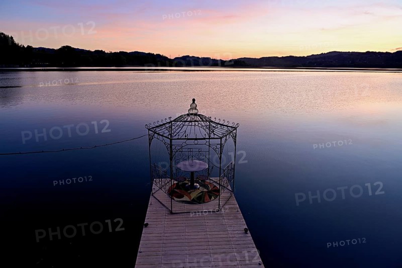 Table with two chairs on a pier at Lac d'Aiguebelette, Great Natural Lake, Aiguebelette-le-Lac, Savoie Department, France