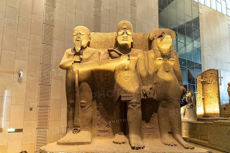 Group of statues with Pharaoh Ramesses II, creator god Ptah and the lion goddess Sekhmet in the Grand Egyptian Museum in Giza, Egypt