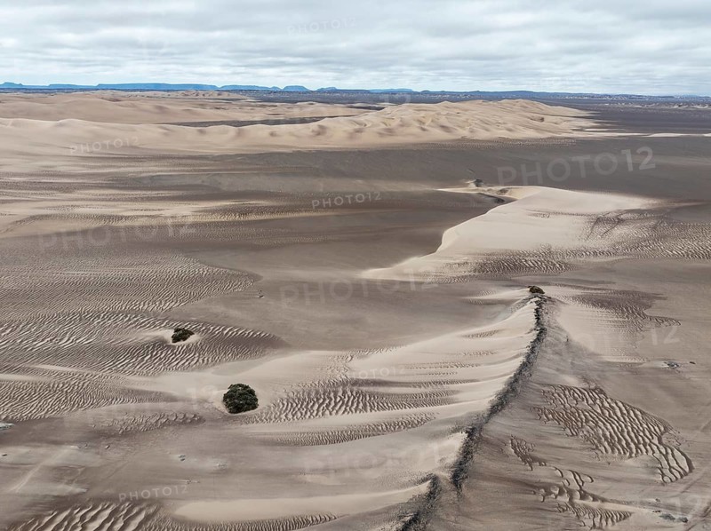 Barchan dunes and sand patterns at the edge of the Namib Desert. Aerial view. Drone shot. Skeleton Coast, Namibia