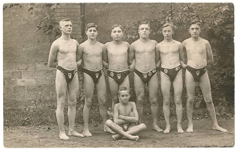Bathing, swimwear, leisure, summer, Six boys and a little boy in swim shorts pose in front of a wall, 1924