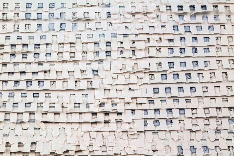 Close-up of overlapping ripped and torn out white perforated pages background from spiral bound telephone and address book, Studio Composition, Quebec, Canada