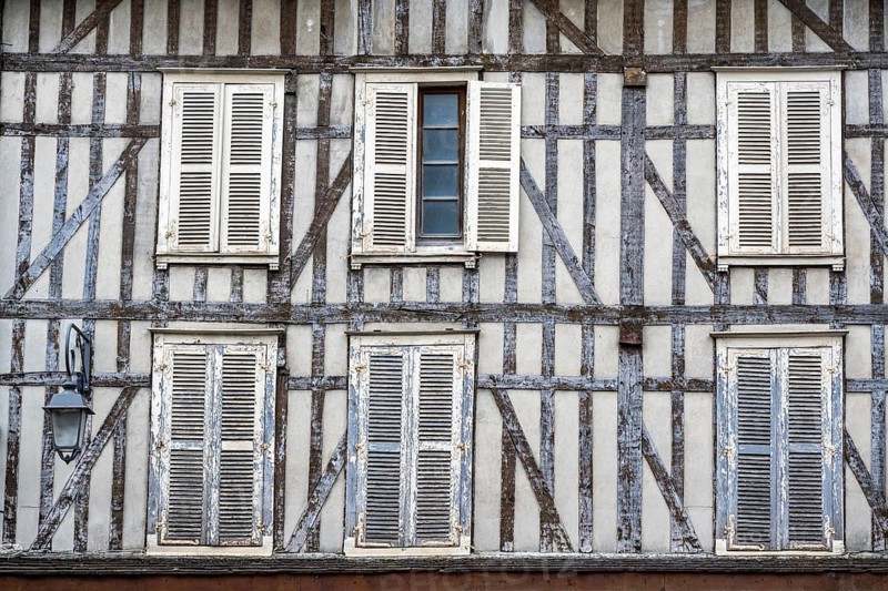 Detailed view of a historic half-timbered house with closed shutters in the old town of Troyes, Aube department, Grand Est region, France