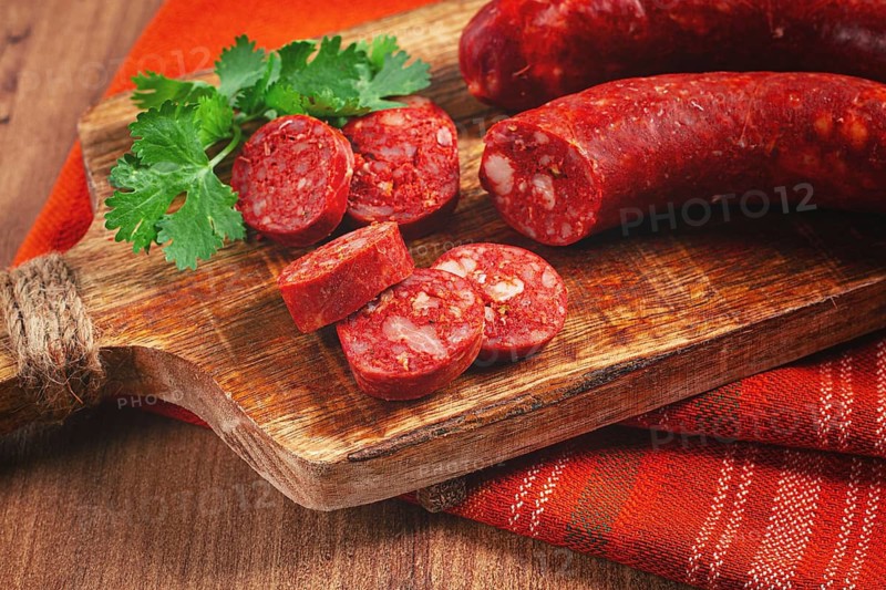 Spicy Chorizo sausage, on a cutting board, on a wooden table