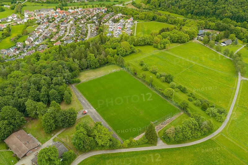Extensive soccer field integrated into green rural landscape with village, Aidlingen sports field, Böblingen district, Germany