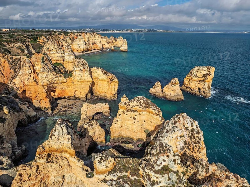 Drone view of Ponte da Piedade in Lagos, Algarve, Portugal, with cliff coves, sea stacks and clear ocean