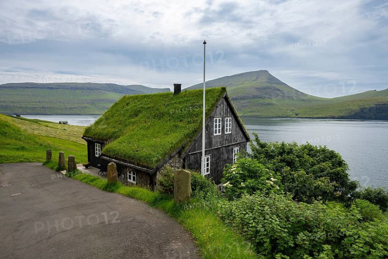 Traditional house with grass roof in the village of Bøur, Vágar Island, Faroe Islands, Denmark