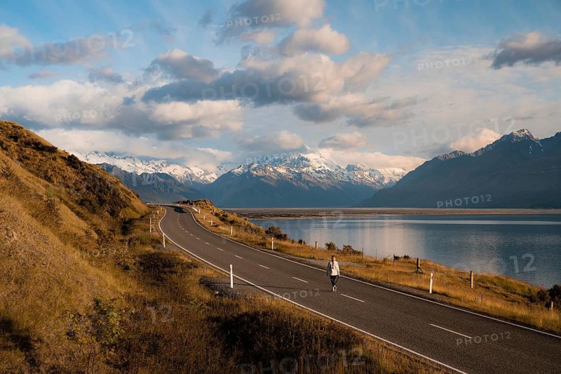 Aerial view of person walking on road on Lake Pukaki with Mount Cook in the background, New Zealand