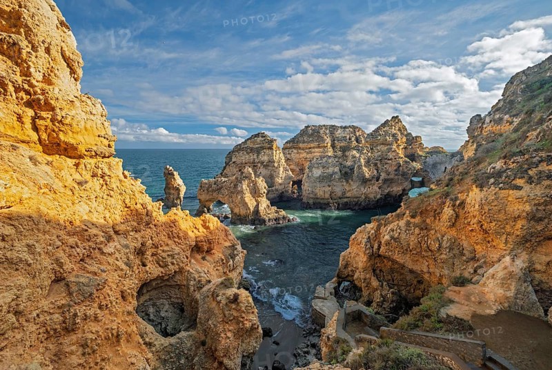 The ocean cove at Ponte da Piedade, Lagos, Algarve, Portugal, is bordered by golden cliffs and sea stacks