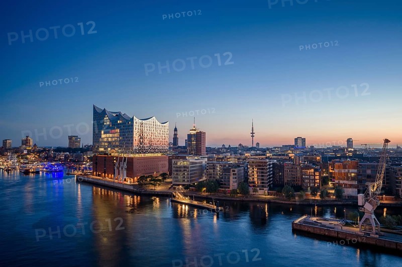 Aerial view of the sunrise on the Elbe with Elbe Philharmonic Hall, St Michael's Church (Michel) and Heinrich Herz Tower, Hamburg, Germany
