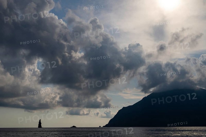 Silhouette of a towering monumental rock pin off the island of Filicudi, Aeolian or Lipari Islands, southern Italy, Italy