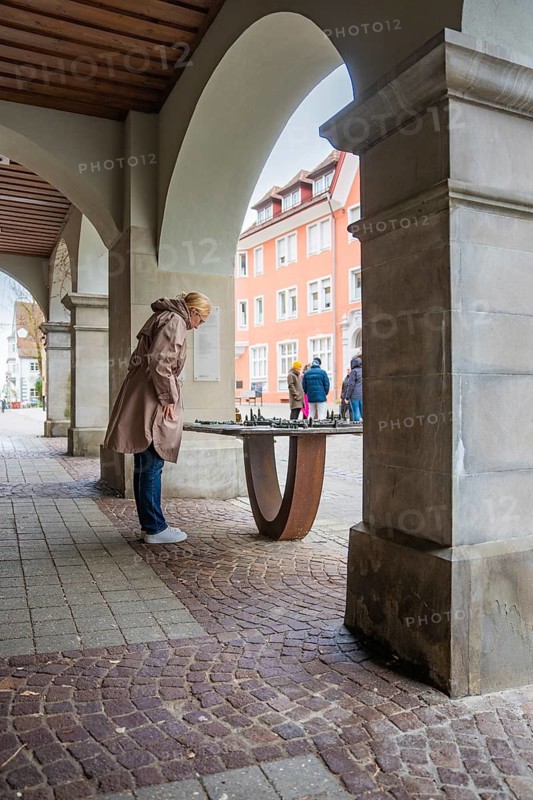 Person looking at a city model under arcades in the city, Isny, Allgäu, Bavaria, Germany