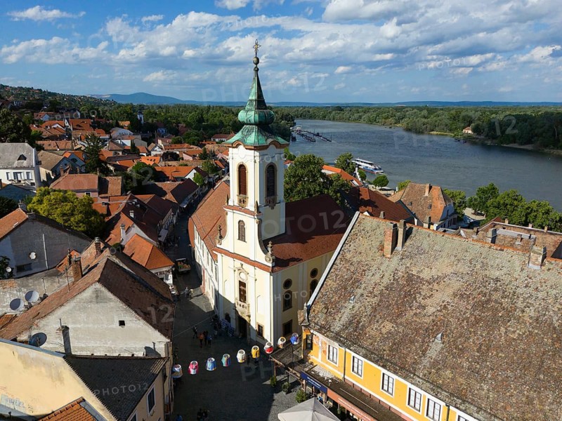 Urban view near the river and a church in the center, lively with people, under blue sky, aerial view, Blagovestenszka Serbian Orthodox Church, Szentendre, Sankt Andrä, Danube River, Pest County, Central Hungary Region, Hungary