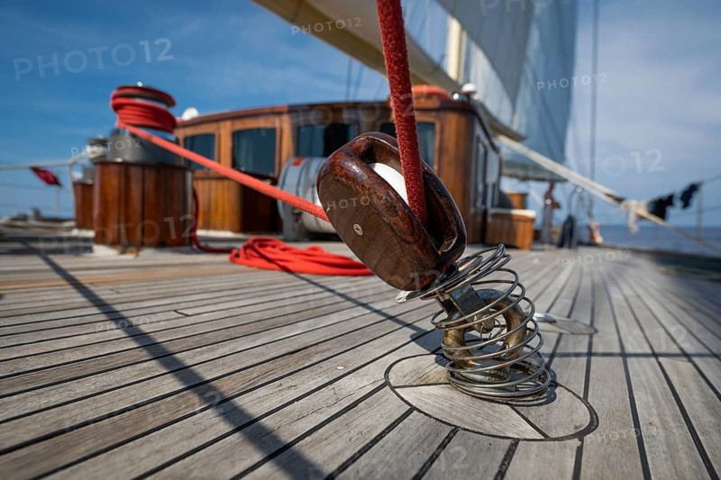 Detailed view of the deck structure of a sailing ship with rope or line and pulley or block in the foreground, Aeolian or Lipari Islands, Sicily, Southern Italy, Italy