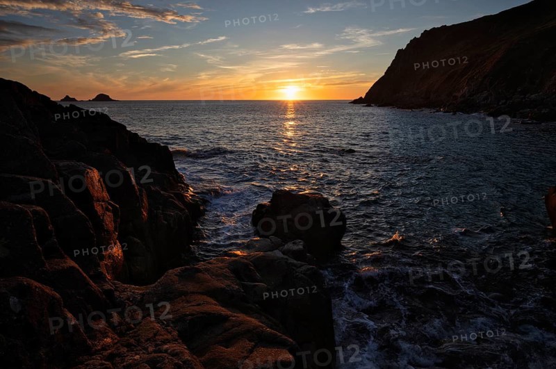 Evening, sunset at sea, The Brisons rock formation in the background, Cot Valley Beach, Porth Nanven, coast, St Just in Penwith, Cornwall, England, Great Britain, Great Britain
