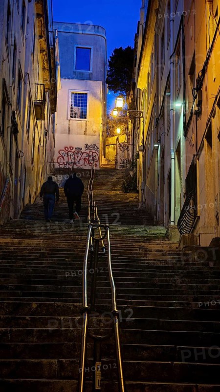 Narrow steep staircase in an old town of Lisbon illuminated at night, Lisbon, Portugal