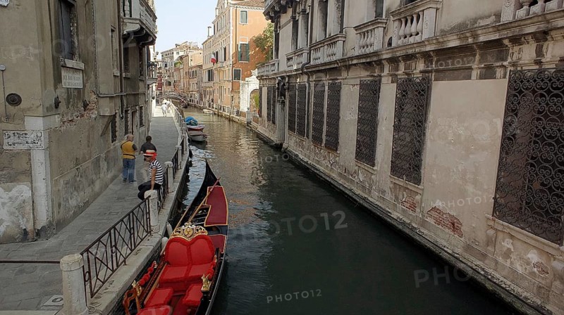Gondola on a canal in Venice surrounded by old buildings, Venice, Veneto, Italy