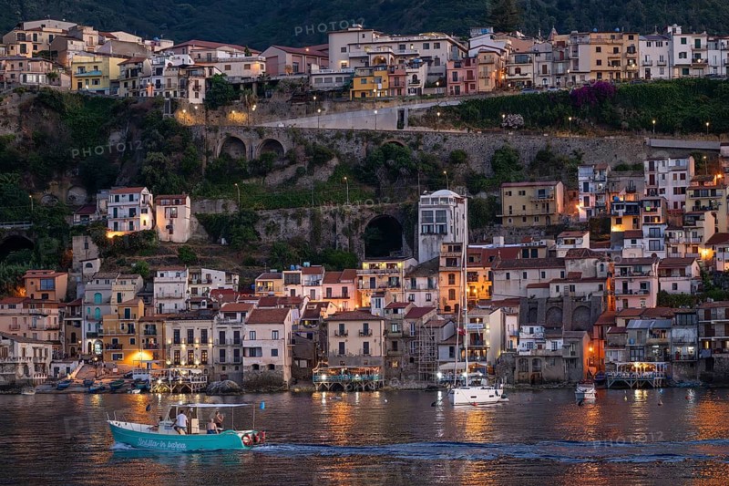 Motorboat against the backdrop of Scilla in the evening, Strait of Messina, Calabria, Italy