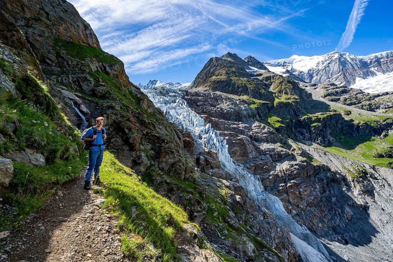 Mountaineers on hiking trail in front of mountain panorama, picturesque high-alpine mountain landscape with Lower Eismeer glacier and Grindelwald-Fiescherfirn glacier, hike to Schreckhornhütte, Bernese Oberland, Switzerland