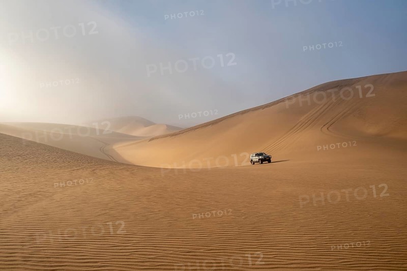 Off-road vehicle between high dunes, sea of dunes, Sandwich Harbour, impressive desert landscape, Namib Naukluft Park, Namib Desert, Namibia