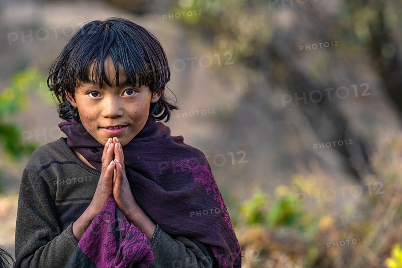 Portrait, young girl folding her hands in greeting Namaste, indigenous people of the Tsumba Tibetan ethnic group, Tsum Valley, Himalayas, Nepal