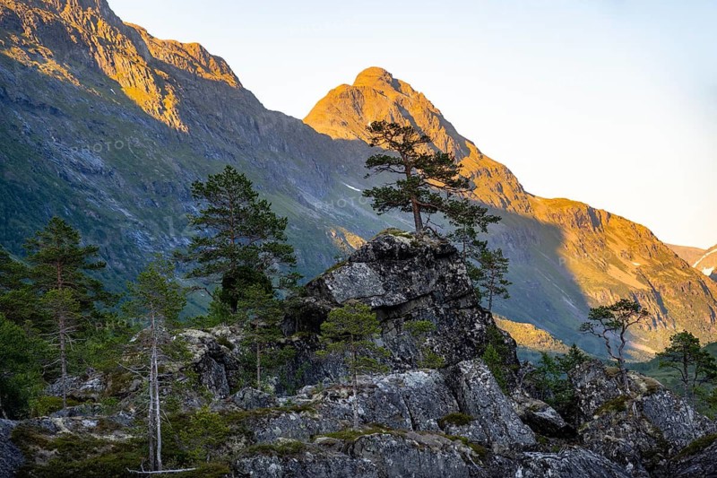 Picturesque mountain landscape in the Innerdalen high valley, silhouettes in front of mountain peaks, reflection in Lake Innerdalsvatna, Trollheimen Mountain Area, Sunndal, Møre og Romsdal, Norway