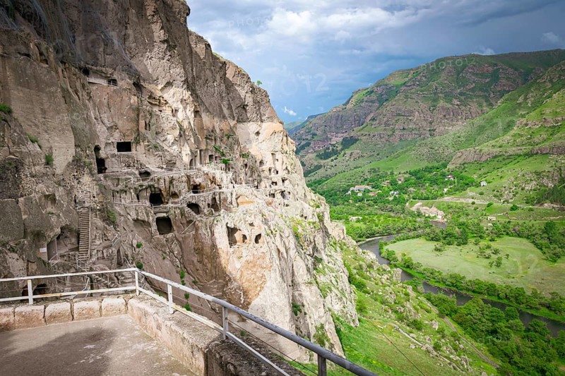 Panoramic viewpoint of VArdzia city caves with green canyon in background. Georgia
