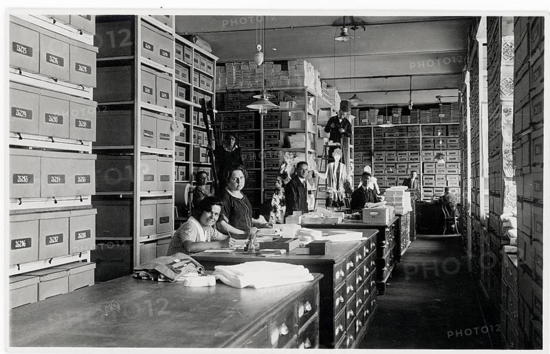 Goods warehouse, sorting, stacking, sales warehouse, employee, woman, sales, shop, business, profession, twenties, saleswoman, an archive room full of shelves and boxes, with people working at desks, around 1928