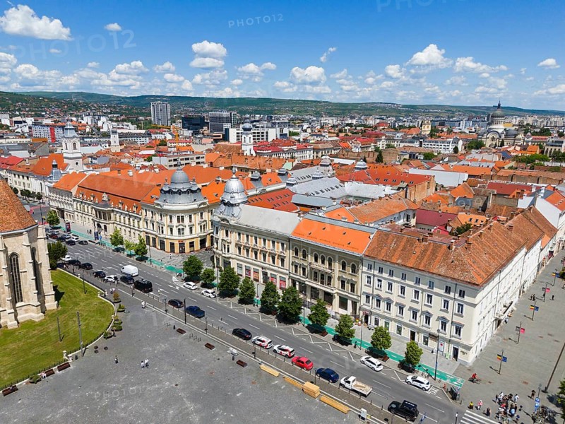 View of an urban landscape with historic buildings and red roofs under blue sky, aerial view, houses at Unification Square, Cluj-Napoca, Cluj, Transylvania, Transylvania region, Romania