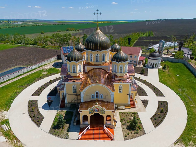 Orthodox church with distinctive domes and crosses nestled in a rural landscape, aerial view, Nicoreni monastery Sf. Ilie, Nicoreni, Drochia, Bessarabia, Republic of Moldova, Moldova