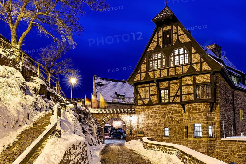 Half-timbered house during the blue hour, illuminated by warm lighting, surrounded by snow and trees, Das Hotel an der Wartburg near Eisenach in Thuringia