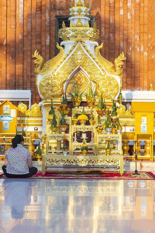 Altar for offerings to Buddha, Dharma and Sangha, in front of the chedi at Wat Phra That Phanom, temple complex in Amphoe That Phanom, Nakhon Phanom Province, Isan, Thailand