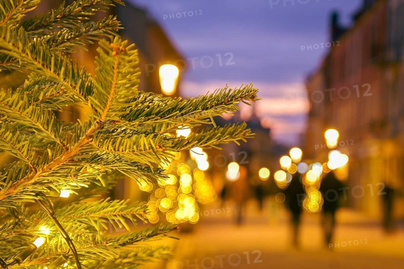 Blurred zoom out background city street with Christmas illuminations, blurred holiday background. Christmas lights and Christmas decorations on the street. Banner, designs. copy space.Xmas new year