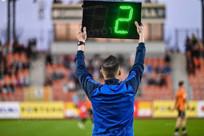 Sideline referee shows 2 minutes added time during the football match in Glogow, Poland