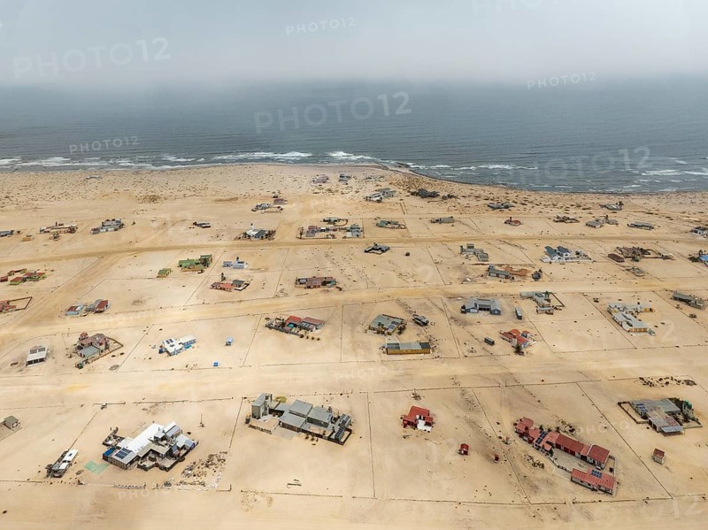 The odd holiday settlement of Wlotzkasbaken at the Atlantic coast. Aerial view. Drone shot. Namib Desert, Skeleton Coast, Namibia