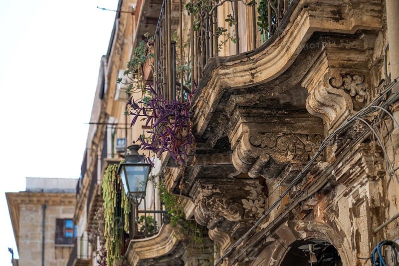 Weathered, richly ornamented balconies of a historic building, Palermo, Sicily, Italy