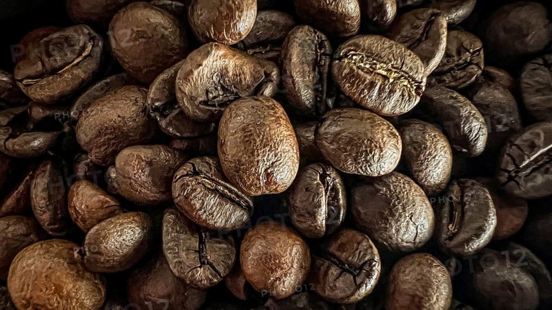 Close to dark coffee beans, the texture is detailed and intense, coffee beans