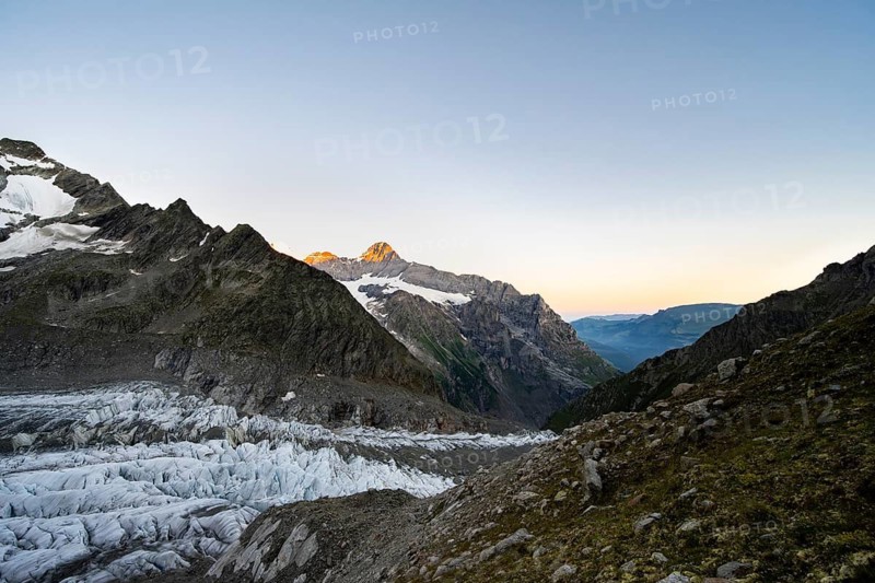 Impressive high-alpine landscape, Eiger mountain summit with alpine glow at sunrise, Upper Arctic Ocean glacier, Bernese Alps, Bernese Oberland, Switzerland