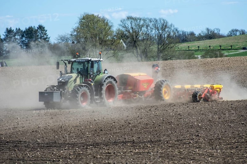 Farming, sowing with tractor in springtime in dusty arable field in Ystad municipality, Skåne county, Sweden, Scandinavia