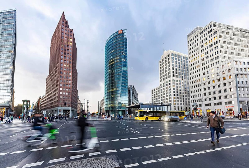 Potsdamer Platz Berlin in the evening with traffic on the streets. When it rains, the skyscrapers are reflected in puddles of water. Berlin, Germany