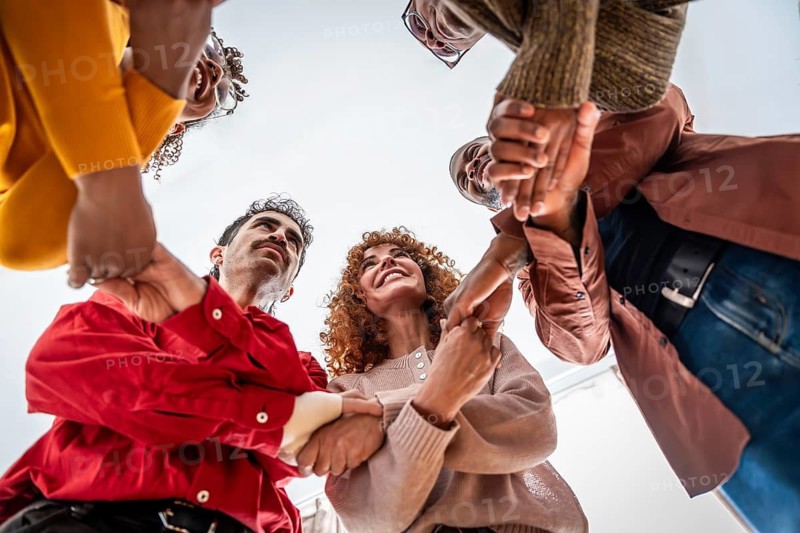 Diverse adults in a support circle holding hands, symbolizing unity, empathy and teamwork in a community or therapy setting, fostering trust, inclusion and well being