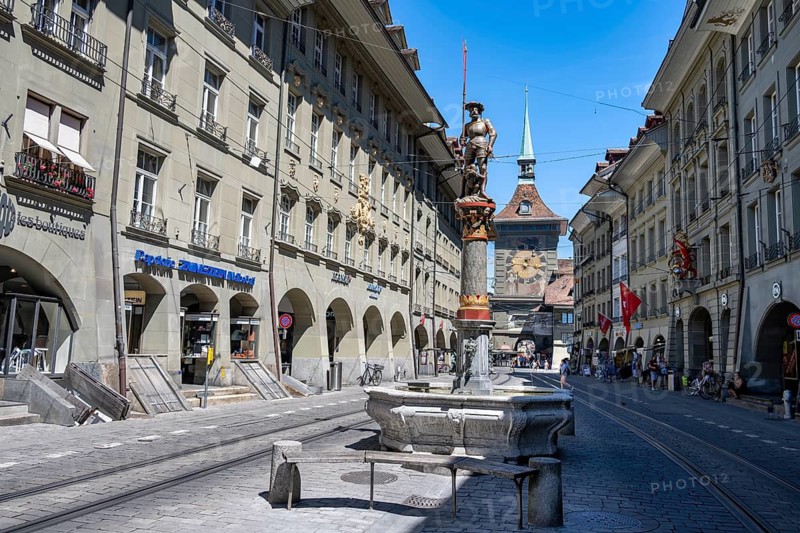 Marktgasse with historic houses and shooting fountains, clock tower Zytglogge behind, old town, Bern, Canton of Bern, Switzerland