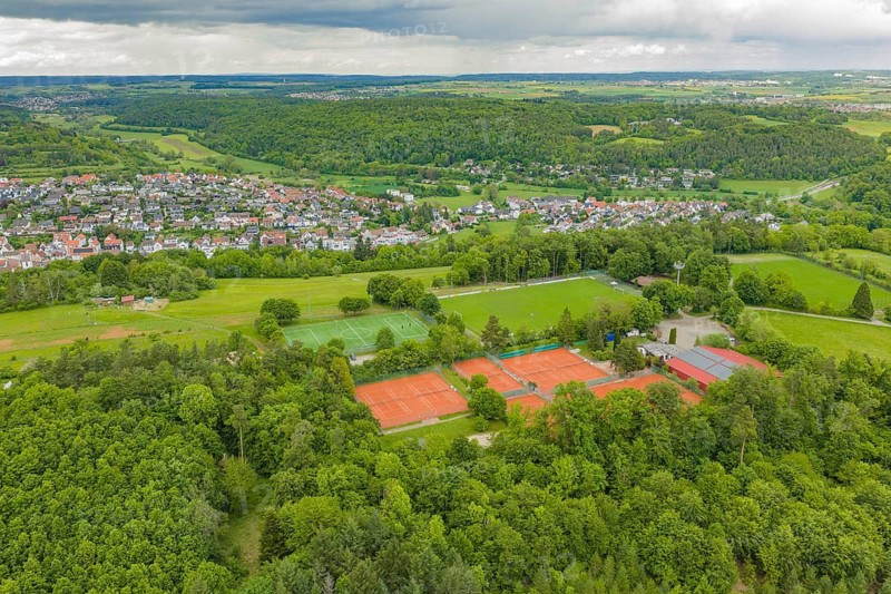 Panorama of tennis and soccer fields in a green, natural village landscape, Aidlingen sports field, Böblingen district, Germany
