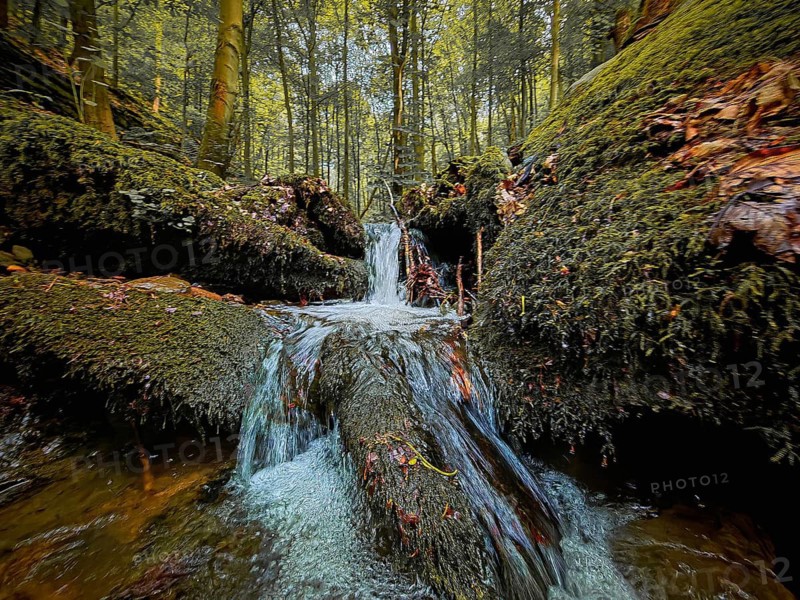 A waterfall on the Werre Bach in a moss-covered forest with intense lighting, quiet, melancholy atmosphere, atmospheric, hiking in the Schwarza Valley nature park Reserve, Thuringian Highlands, Thuringian Forest Nature Park