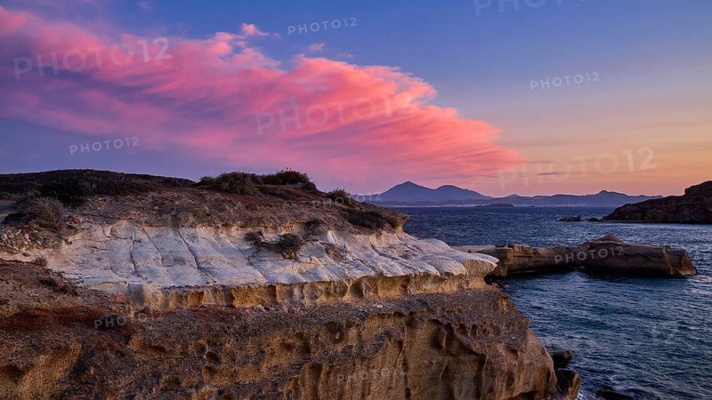 Mauve sky at sunset over rocky coast and sea, Aspragremna, White Cliffs, Mavorspilia Beach, Kimolos Island, Kimolos, Cyclades, Greek Islands, Greece