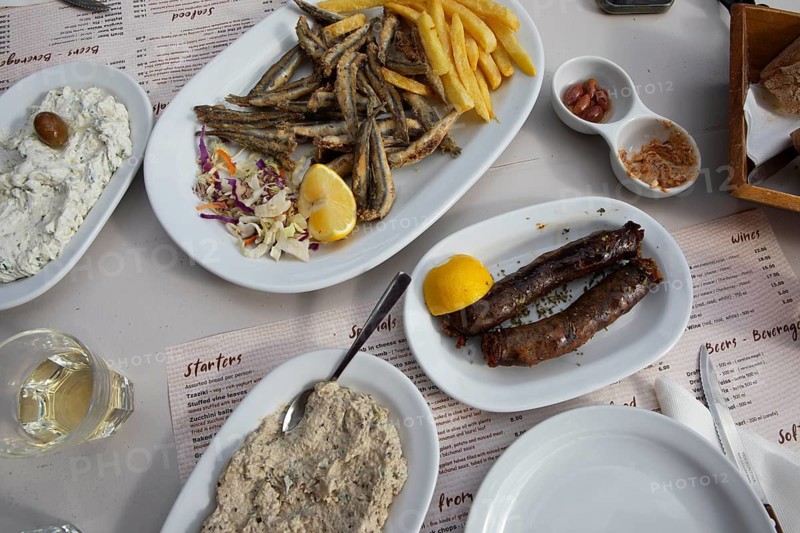 Sfakian sausages, eggplant puree, tzaziki and fried sardines, traditional dish in Crete, Greece