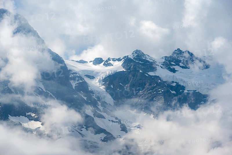 Clouds move around glaciated mountain peaks, view from Tanzbödeli, Bernese Alps, Bernese Oberland, Switzerland